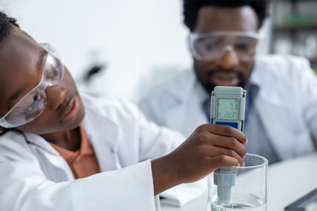 African american schoolgirl doing scientific experiments at the chemistry lessonの写真素材