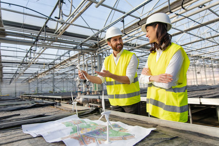 Two engineers working on the construction plan and looking involvedの写真素材