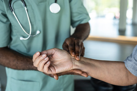 Doctor checking the pulse of a patient in the clinicの写真素材