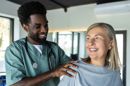Doctor correcting the patients posture and both looking contented and smiling