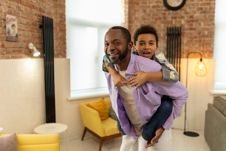 Dad and son hugging and looking happy and enjoyed