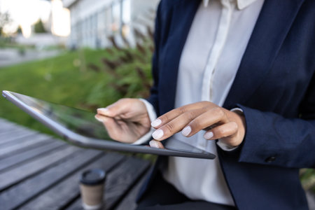 Close up of womans hands scrolling something on a tablet