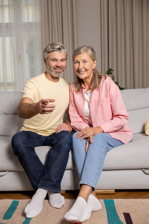 Mature happy couple spending time at home and looking excited