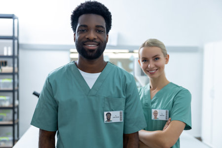 Woman doctor standing in hospital laboratory consulting with diverse man colleagueの写真素材