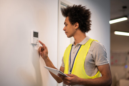 Service man checking the sensor door locker and looking involved