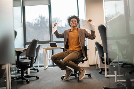 Office employee having fun at workplace finishing tasks successfully enjoying breakの写真素材