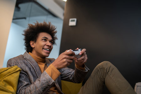 Dark-skinned man playing video games and looking involved