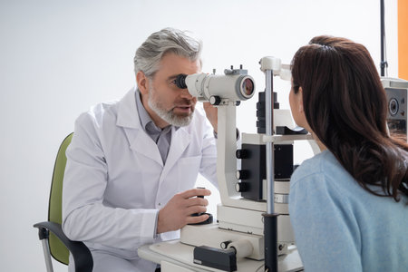 Male optician testing woman sight and providing eye consultationの写真素材