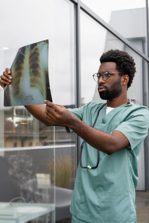 Man doctor examines X-ray scan in clinic