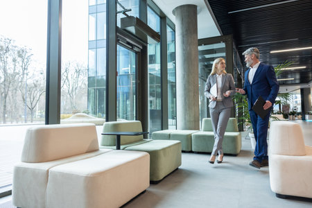 Business partners walking in the business center hall and talkingの写真素材