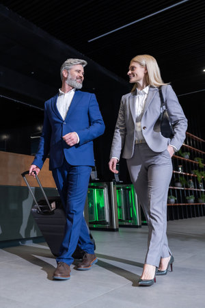 Business owner meeting a partner in the airport and going to the exitの写真素材