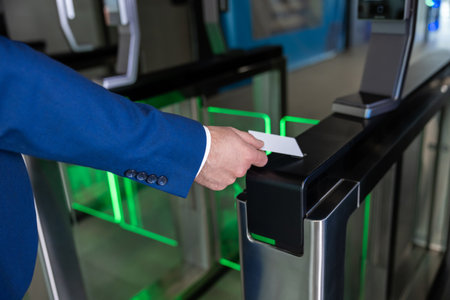 Close up picture of male hand with an access card on a security controlの写真素材