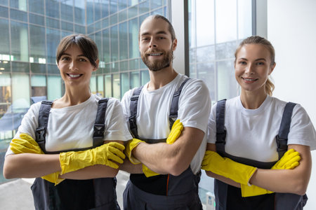 Cleaning team after work in the office looking contented and confidentの写真素材