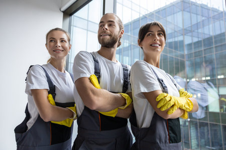 Cleaning team after work in the office looking contented and confidentの写真素材