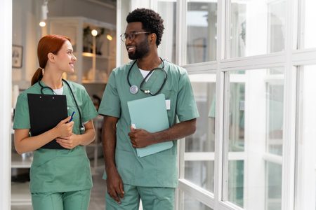 Hospital staff engaged in professional discussion while walking in medical hall