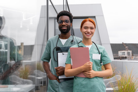 Red haired woman and African American man therapists in hospital officeの写真素材