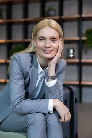 Smiling cute blonde woman looking contented and positiveの写真素材