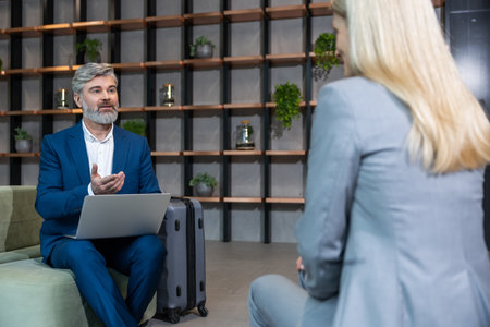 Mature business man having an interview with a work candidate and looking involvedの写真素材