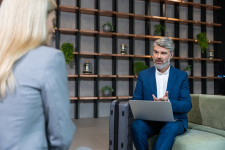 Mature business man having an interview with a work candidate and looking involvedの写真素材