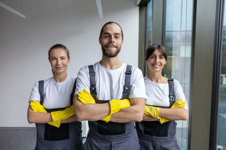 Cleaning team after work in the office looking contented and confidentの写真素材