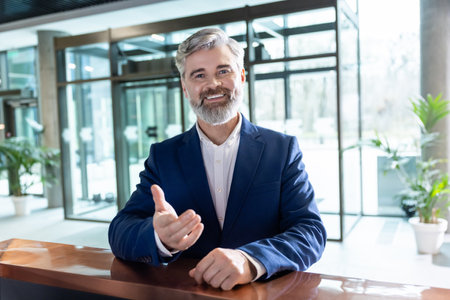 Businessman at reception desk in business hubの写真素材
