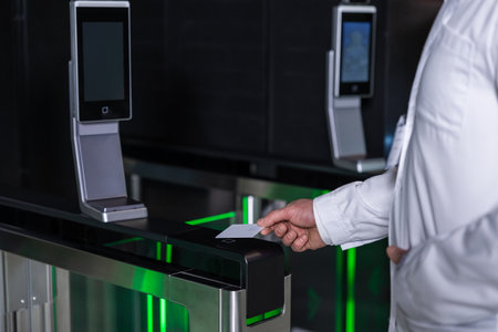 Male doctor in lab coat entering clinic by using access card