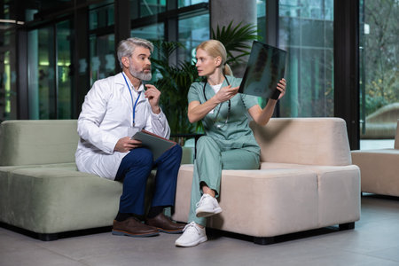 Two colleagues discussing xray results and looking involvedの写真素材