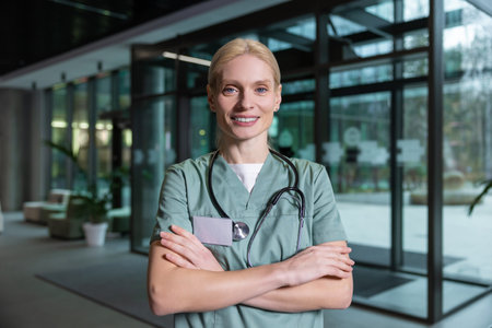 Pretty blonde female doctor looking contented and joyfulの写真素材