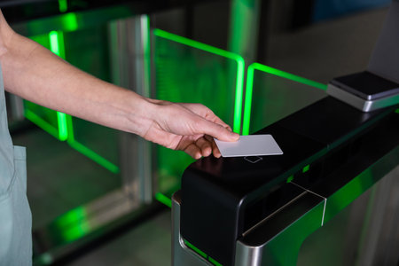 Close up of a female hand with an access card on the security controlの写真素材