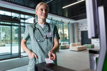 Female blonde doctor passing through security by using access cardの写真素材