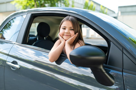 Little girl in automobile during summer travelの写真素材