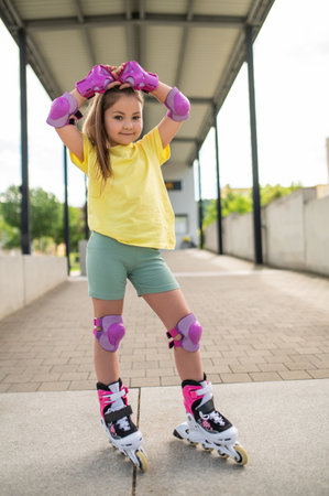 Little girl roller-skating outside