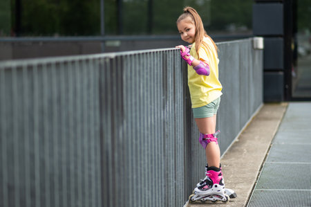 Little girl enjoying roller-skating outside