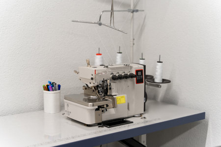 Dress designer studio with sewing equipment and table in the middleの写真素材