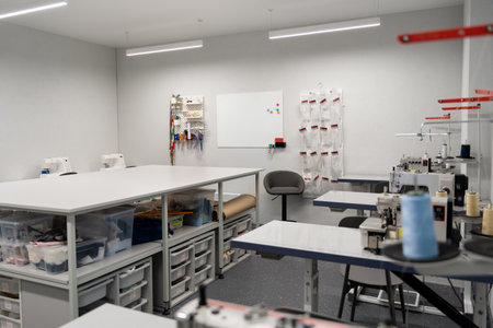 Dress designer studio with sewing equipment and table in the middleの写真素材