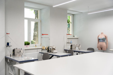 Dress designer studio with sewing equipment and table in the middleの写真素材