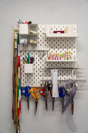 Colorful scissors and measurement bands on the wall shelves