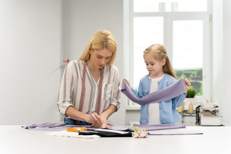 Blonde woman tailoring a new model in her design studioの写真素材