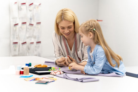 Cute blonde child cutting out a new model in a design studioの写真素材