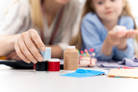Mom and kid working on a new model in a design studioの写真素材