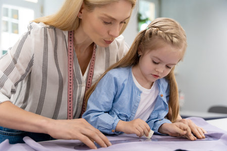 Mom and kid working on a new model in a design studioの写真素材