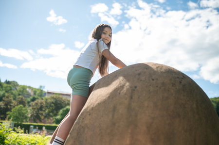 Young kid playing in park playground in nature during fun spring dayの写真素材
