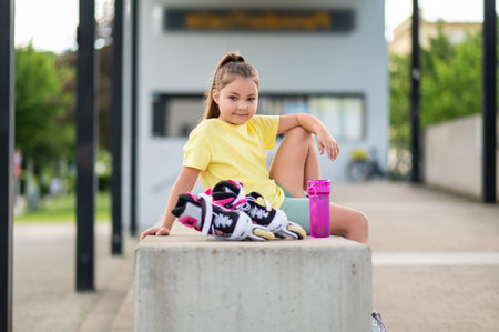 Girl preparing for roller-skating outside enjoying fun active summer sportの写真素材