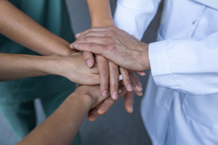 Top view of people hands clasping together tightly