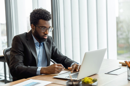 Elegant businessman working in his office and having a business video callの写真素材