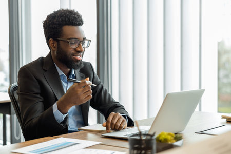 African american businessman having a video call and looking excitedの写真素材
