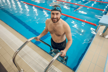 Handsome caucasian man spending time in the swimming poolの写真素材