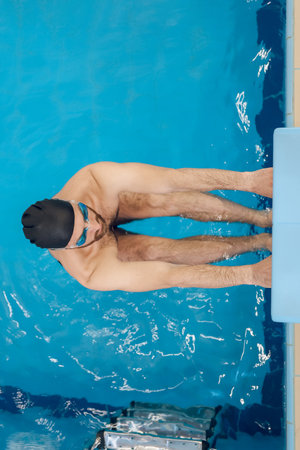 Man in swimming glasses having a workout in the poolの写真素材