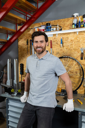 Mechanic in white gloves posing in his workshopの写真素材