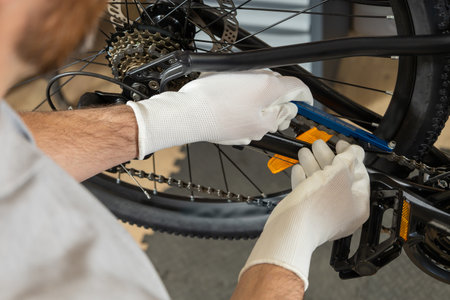 Mechanic lifting bicycle wheelの写真素材